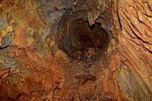 interesting original cave in the Turkish mountains with stalactites and stalagmites creating the background photo