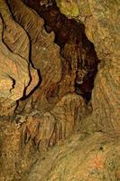 interesting original cave in the Turkish mountains with stalactites and stalagmites creating the background photo