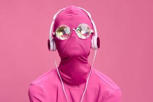 Creative crazy pink photo on a pink background with pink clothes and accessories, cyberpunk concept and conceptual art photography