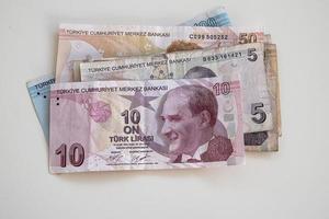 Turkish paper banknotes lying on a white table photo