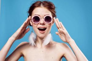 cheerful emotional woman wearing sunglasses fashion bright makeup decoration blue background photo
