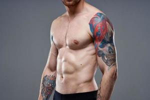 man with pumped up press tattoo on his arms cropped view of workout photo