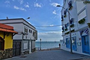 ver de el blanco casas con azul persianas en el antecedentes de el océanos en el Español isla de furertaventra foto