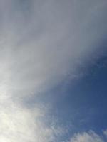 Beautiful white clouds on deep blue sky background. Large bright soft fluffy clouds are cover the entire blue sky. photo