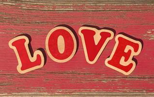 word love made of wooden letters on old red board photo