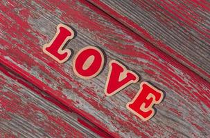 word love on plank of old wooden bench photo