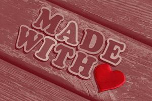 text made with love made of wooden letters on wood background photo