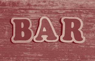 word bar made of wooden letters on wood background photo