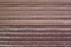 Background texture of plastic panels on gates covered with dust and dirt. Smudges and stains. Brown horizontal stripes. photo