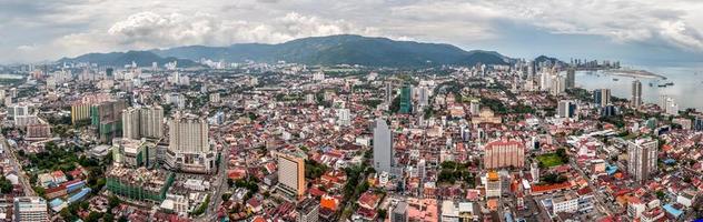 Panoramic view of Georgetown city on Penang island in Malaysia from a skyscraper. A beautiful historic multicultural city. High mountains on the horizon. photo