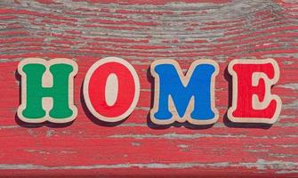 word home made of wooden letters on old wooden board photo
