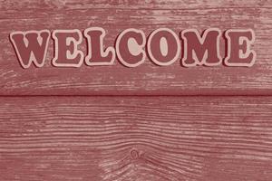 word welcome made of wooden letters on wood background photo