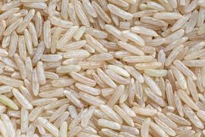 close up of uncooked brown rice grains background photo