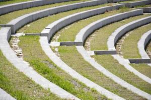 Rows of stairs and grass in the amphitheater. Modern architecture and landscape design in the park. photo