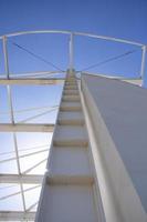 Detail of the steel structure of a modern building against the blue sky. photo