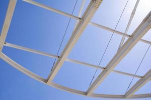 Detail of the structure of a steel structure against the blue sky. photo