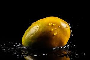 Mango on black background. Generate Ai photo