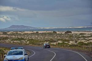 landscape with road and ocean on the spanish canary island of fuertaventra on a sunny day photo