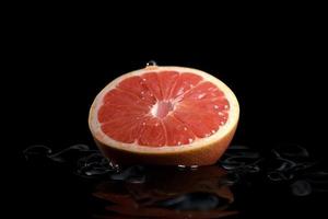 Grapefruit on black background. Generate Ai photo