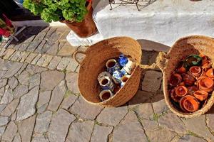 glass items in close-up in straw baskets in front of a souvenir shop photo