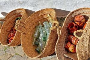 glass items in close-up in straw baskets in front of a souvenir shop photo