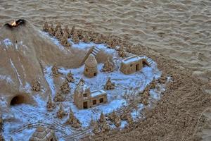 sand sculpture on the beach against the backdrop of the ocean photo