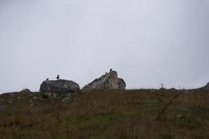 mountain landscape rock stones clouds in the sky grass photo