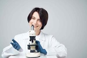 woman laboratory assistant microscope science research studio photo