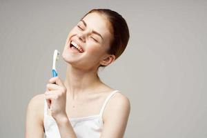 woman toothpaste brushing teeth dental health isolated background photo