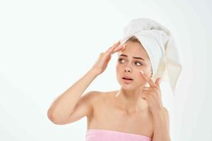 woman holding face skin problems bare shoulders close-up photo