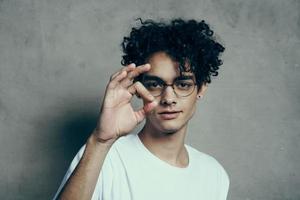 guy in white t-shirt gesturing with hand curly hair emotions Studio photo