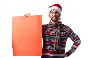 Cheerful man Red paper billboard advertising christmas light background photo