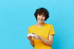 man yellow T-shirt with joystick video games isolated backgrounds photo