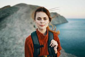 woman with backpack in mountains walk travel adventure freedom photo