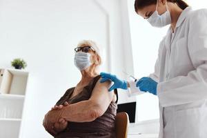 elderly woman with a doctor covid-19 passport virus epidemic photo