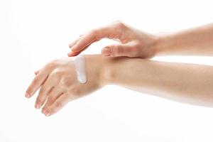 female hands applying cream moisturizing cosmetics massage photo