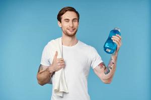 Cheerful man in white t-shirt workout water bottle energy photo