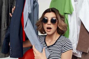 cheerful woman with glasses next to clothes fashion fun emotions photo