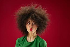 Positive young woman Afro hairstyle green dress emotions close-up color background unaltered photo