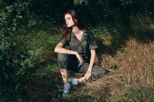 Woman sitting on the ground in the forest green leaves fresh air photo