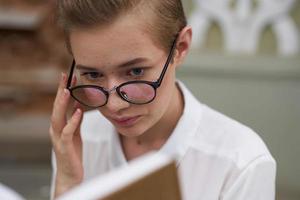 pretty woman with a book in his hands outdoors reading communication photo