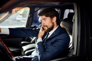 bearded man in a suit in a car a trip to work self confidence photo