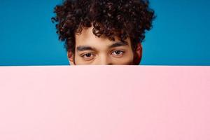 cute guy with curly hair pink poster close-up photo