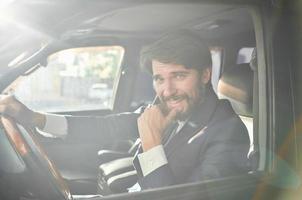 bearded man Driving a car trip luxury lifestyle self confidence photo