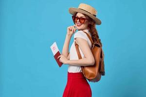 woman in red skirt passport and plane tickets vacation travel flight photo