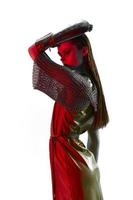 photo pretty woman Glamor posing red light metal armor on hand unaltered