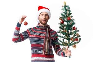 emotional man with a tree in his hands ornaments holiday fun isolated background photo