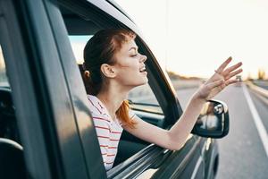 Cheerful woman in car trip journey road photo