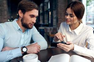 business man and woman look at the phone communication work colleagues photo