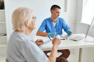 elderly woman patient talking to doctor diagnosis photo